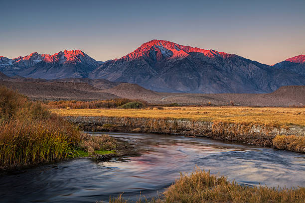 Sierra Nevada at Dawn The Sierra Nevada mountains at dawn seen from the Owens River Valley owens river stock pictures, royalty-free photos & images
