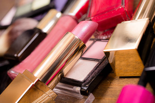 istock Pile of various cosmetics, make-up lie on wooden dressing table. 528567684