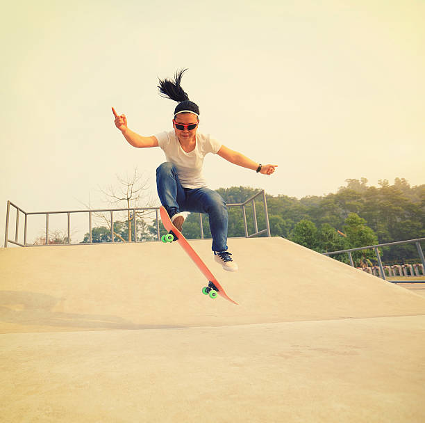 istock skateboarding woman practice ollie at skatepark 528568596