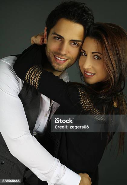 Happy Young Woman Hugging Her Boyfriend Stock Photo - Download Image Now - 20-29 Years, Adult, Arm Around