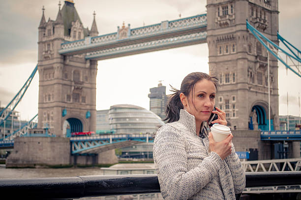 istock Woman talking on a phone while holding a cup of coffee 528568994