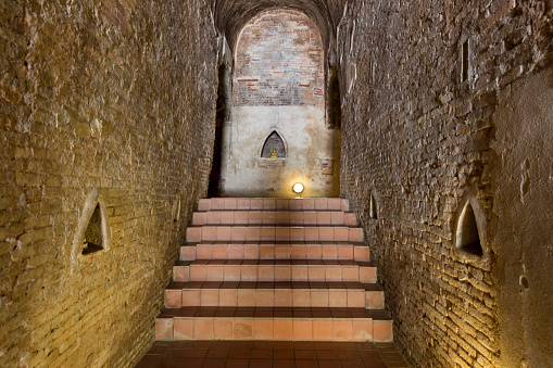 walkway to golden buddha statue in cave tunnel