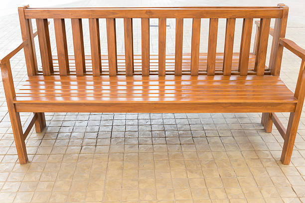 istock brown wooden bench on sidewalk 528569650