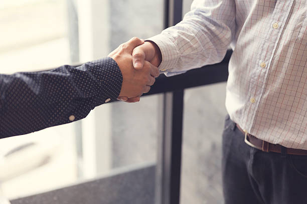 istock businessman handshaking for business acquisiton concept 528570132