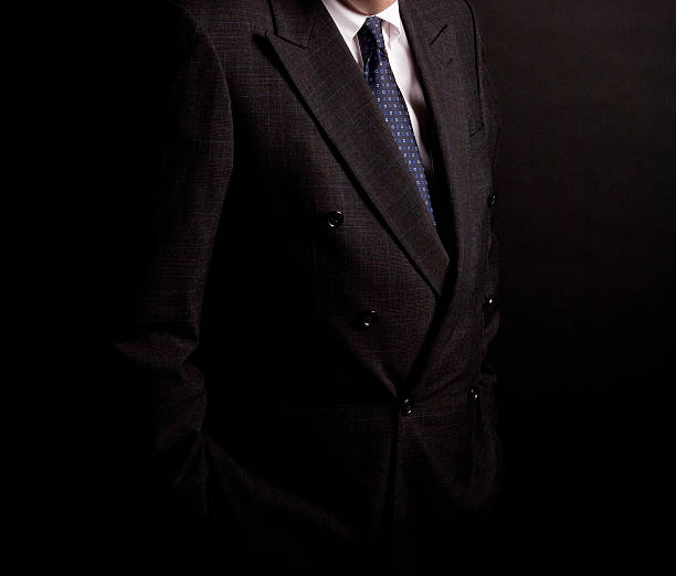 istock man in suit on a black background. studio shot 528570192