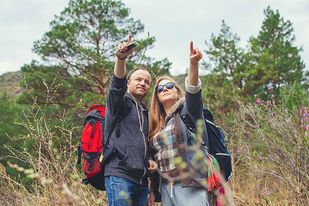istock Young couple in the mountains with backpacks 528570206