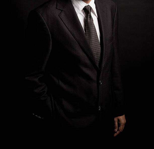 istock man in suit on a black background. studio shot 528570228