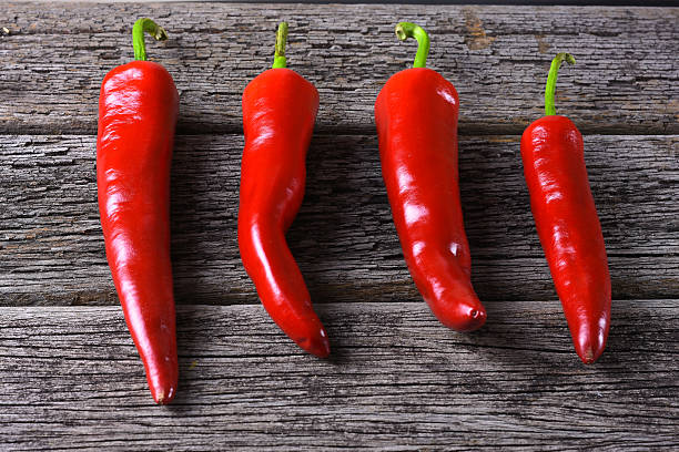 istock Red chilies on the rusty wooden table 528570580
