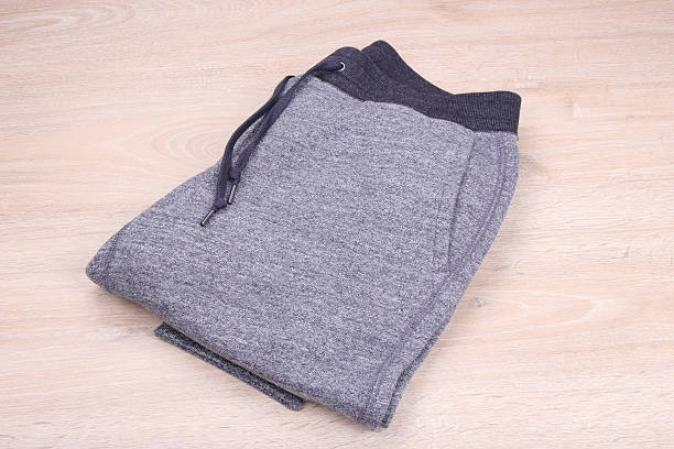 istock Sweatpants on wooden background 528572848
