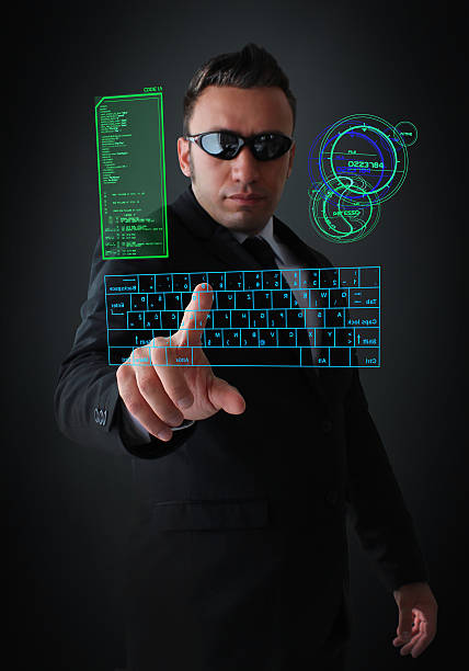 Spy using Virtual Keyboard Mysterious businessman using a virtual computer in near future. mi6 stock pictures, royalty-free photos & images