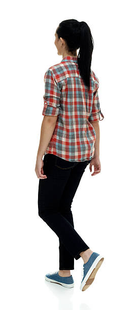 istock Rear view of female walking 528574660