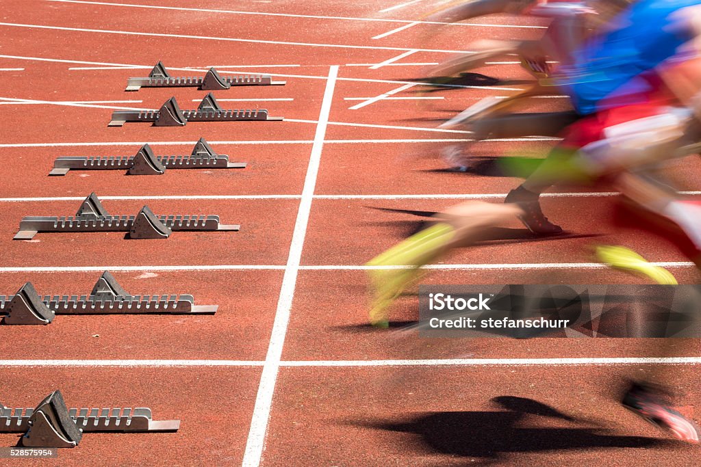 sprint start in blurred motion sprint start in track and field in blurred motion Running Stock Photo