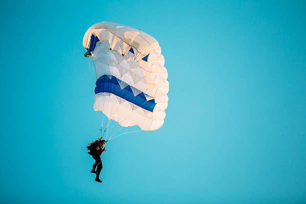 istock Skydiver On Colorful Parachute In Sunny Sunset Sunrise Sky 528576248