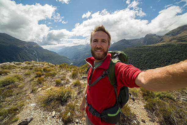 istock One young man hiking, takes selfie portrait 528576746