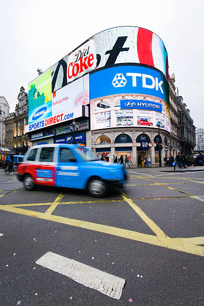 istock london cab driving at piccadilly circus 528577254