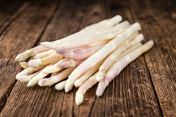 istock White Asparagus (selective focus) on wooden background 528578400