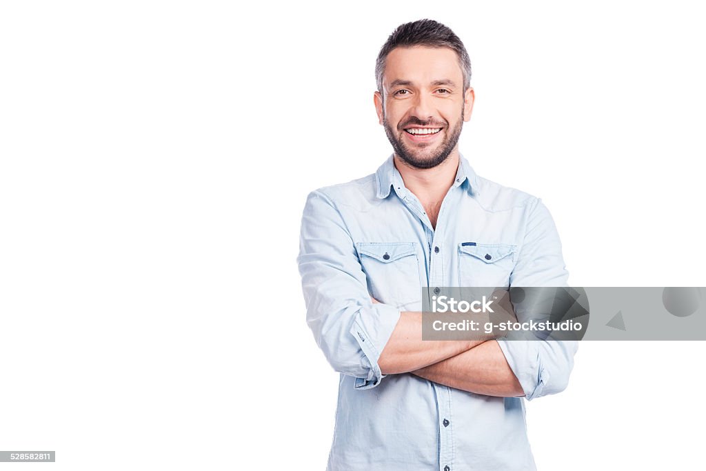 Charming handsome. Handsome young man in casual wear keeping arms crossed and smiling while standing isolated on white background Men Stock Photo