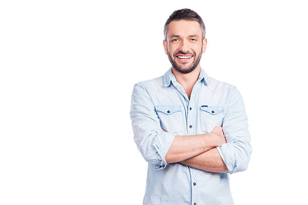 Charming handsome. Handsome young man in casual wear keeping arms crossed and smiling while standing isolated on white background arms crossed photos stock pictures, royalty-free photos & images
