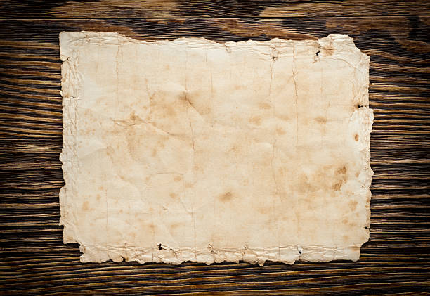 istock Old paper on the wood background 528584543