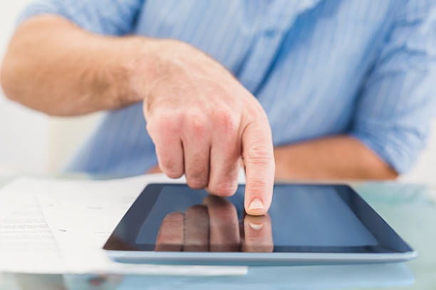 istock Casual businessman using tablet at desk 528587523