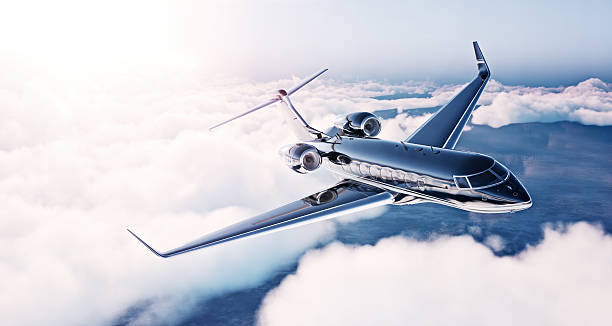 Airplane fly over clouds and Alps mountain on sunset. Front view of a big passenger or cargo aircraft, business jet, airline. Transportation and travel concept.