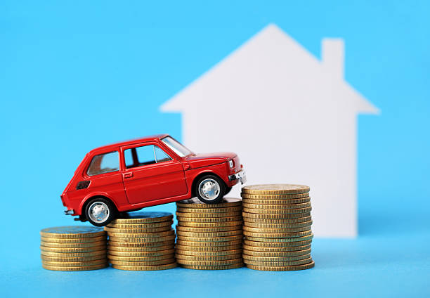istock House, red miniature car and money 528606957