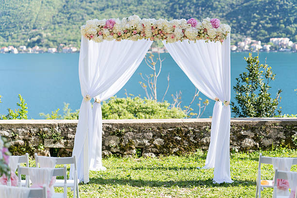 istock arch for the wedding ceremony, decorated with cloth and flowers 528607886