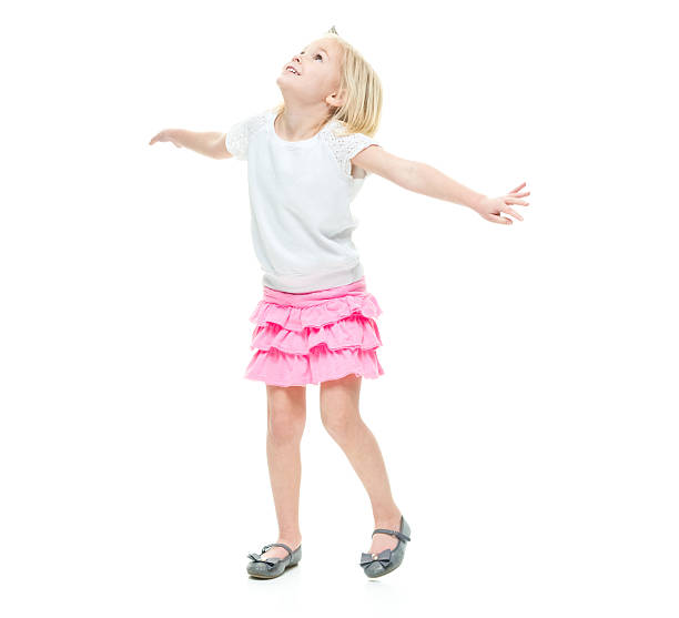 Smiling little girl standing with arms outstretched