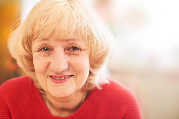 istock Elderly woman in red 528609690
