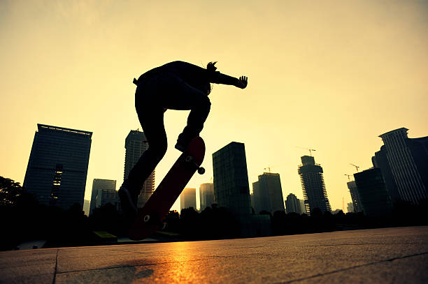 istock skateboarding woman jumping at  sunrise 528609897