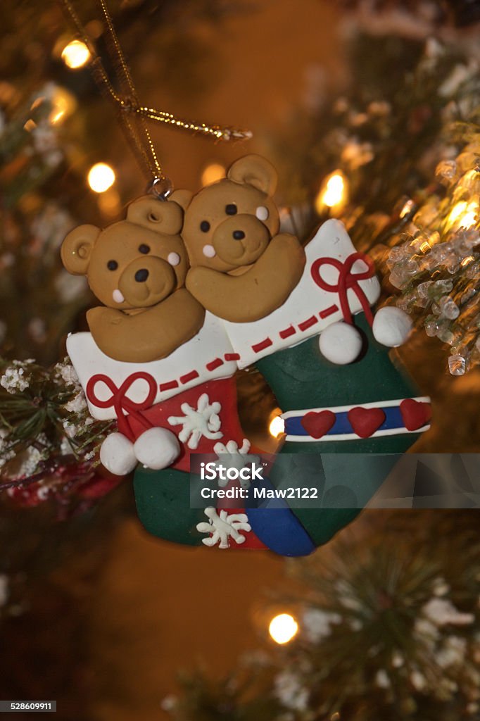 Teddy Bears in Christmas Stockings ornament Two cute teddy bears nestled in Christmas stockings hang together on the tree Celebration Stock Photo