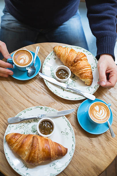 istock Coffee and croissant. Man having french style breakfast (Paris, France) 528611570