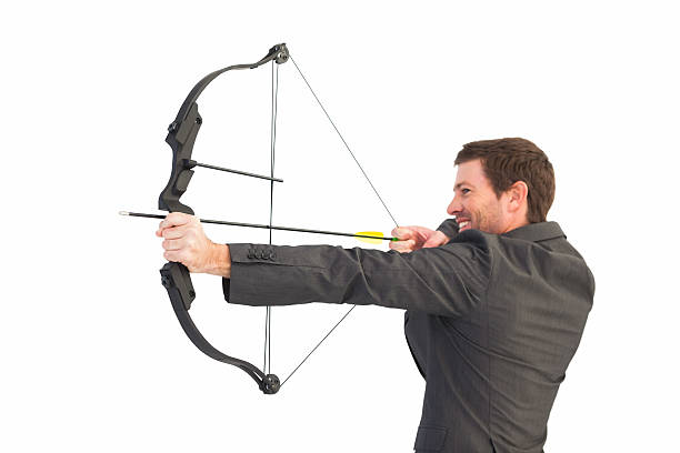 istock Handsome businessman shooting a bow and arrow 528611971