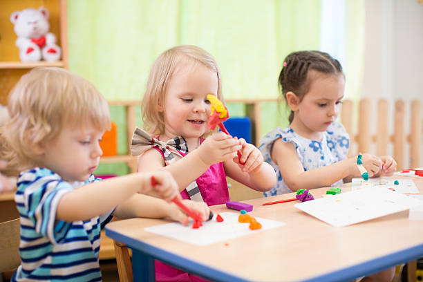 istock kids group making arts and crafts in kindergarten with interest 528611998