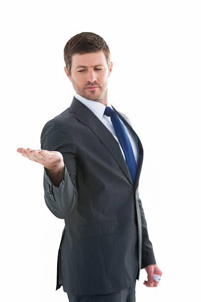 istock Businessman holding hand out in presentation 528612583