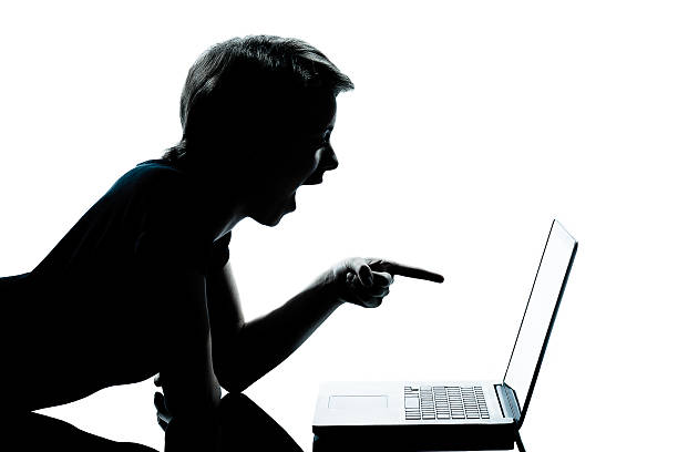istock one young teenager boy or girl silhouette computer computing lap 528612851
