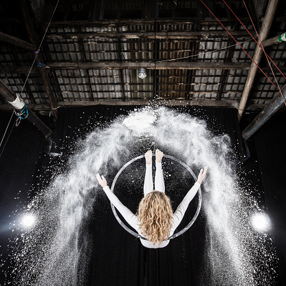 Aerial dancer performance with flour