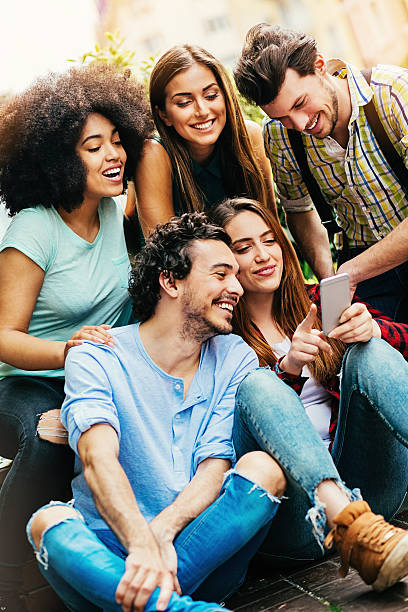 istock Multi-ethnic group of friends with a phone 528613120
