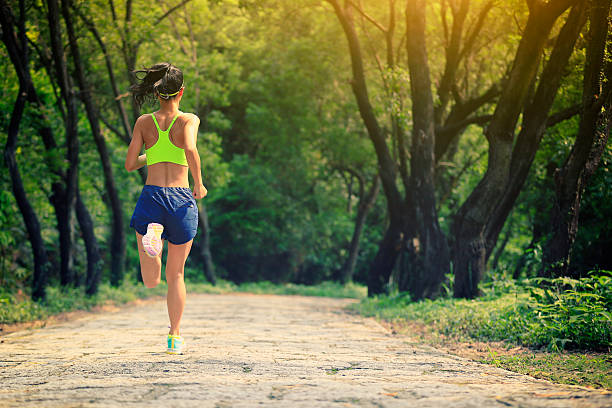 istock young woman trail runner running at forest stone trail 528615472