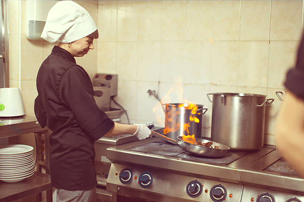 istock Chef Cooking With Fire In Frying Pan 528615494