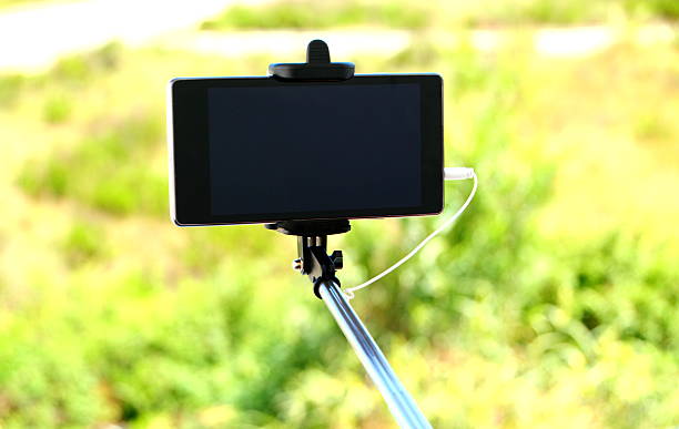 istock selfie stick and mobile phone 528616138