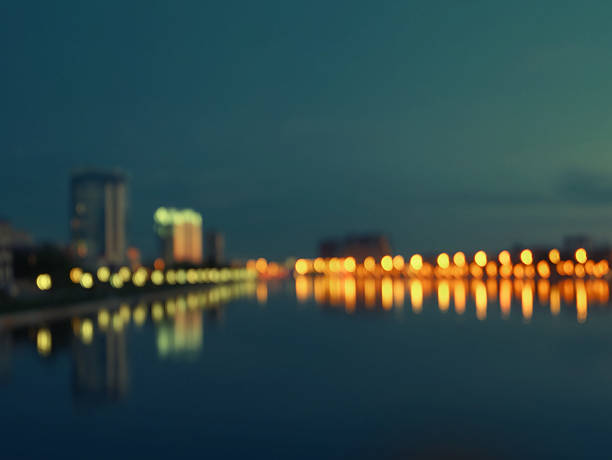 istock City at nighttime riverfront defocused image, toned shot, copyspace 528617868