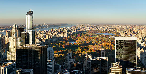 Aerial View, Central Park in Fall with Midtown skyscrapers, NYC Panoramic aerial view on Central Park in fall colors with Midtown skyscrapers, Upper West Side buildings and the George Washington Bridge in the distance. Manhattan, New York City gwb stock pictures, royalty-free photos & images