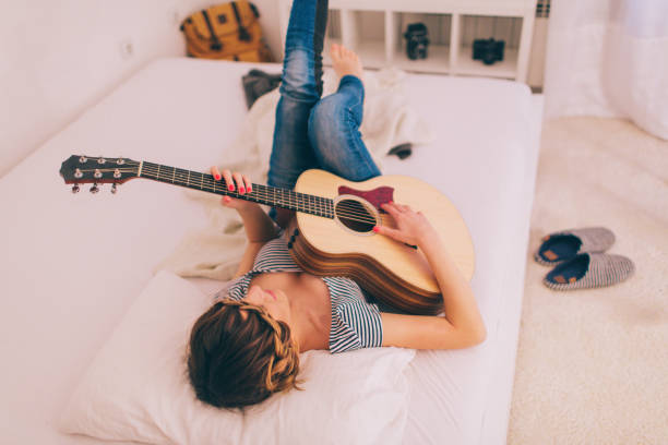 Photo of a young smiling girl who is fond of music and string instruments 
