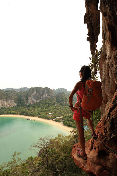 istock young woman backpacker hiking at seaside mountain cliff 528621270