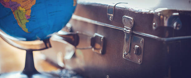 Only two things you need for trip Vintage brown suitcase and world map globe suitcase luggage old fashioned obsolete stock pictures, royalty-free photos & images