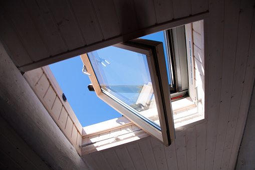 roof open window from indoor with blue sky, wooden ceiling
