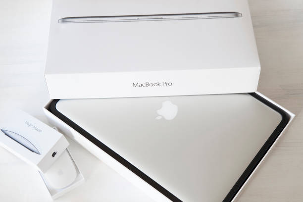 Apple Macbook Pro And Apple Magic Mouse 2 Stock Photo - Download