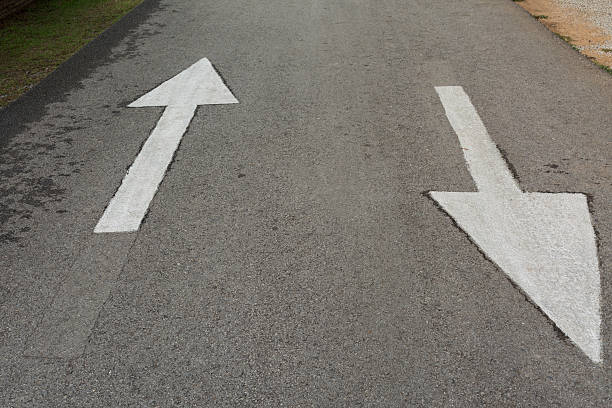 istock two way arrow sign on road 528624484