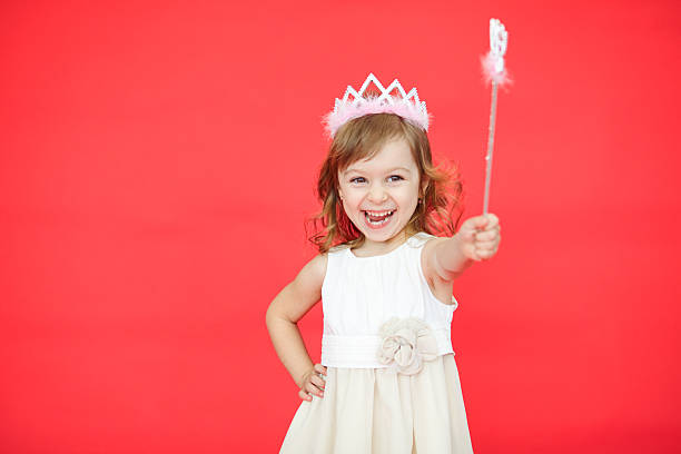 istock Little girl holding a magic wand in her hand 528631196